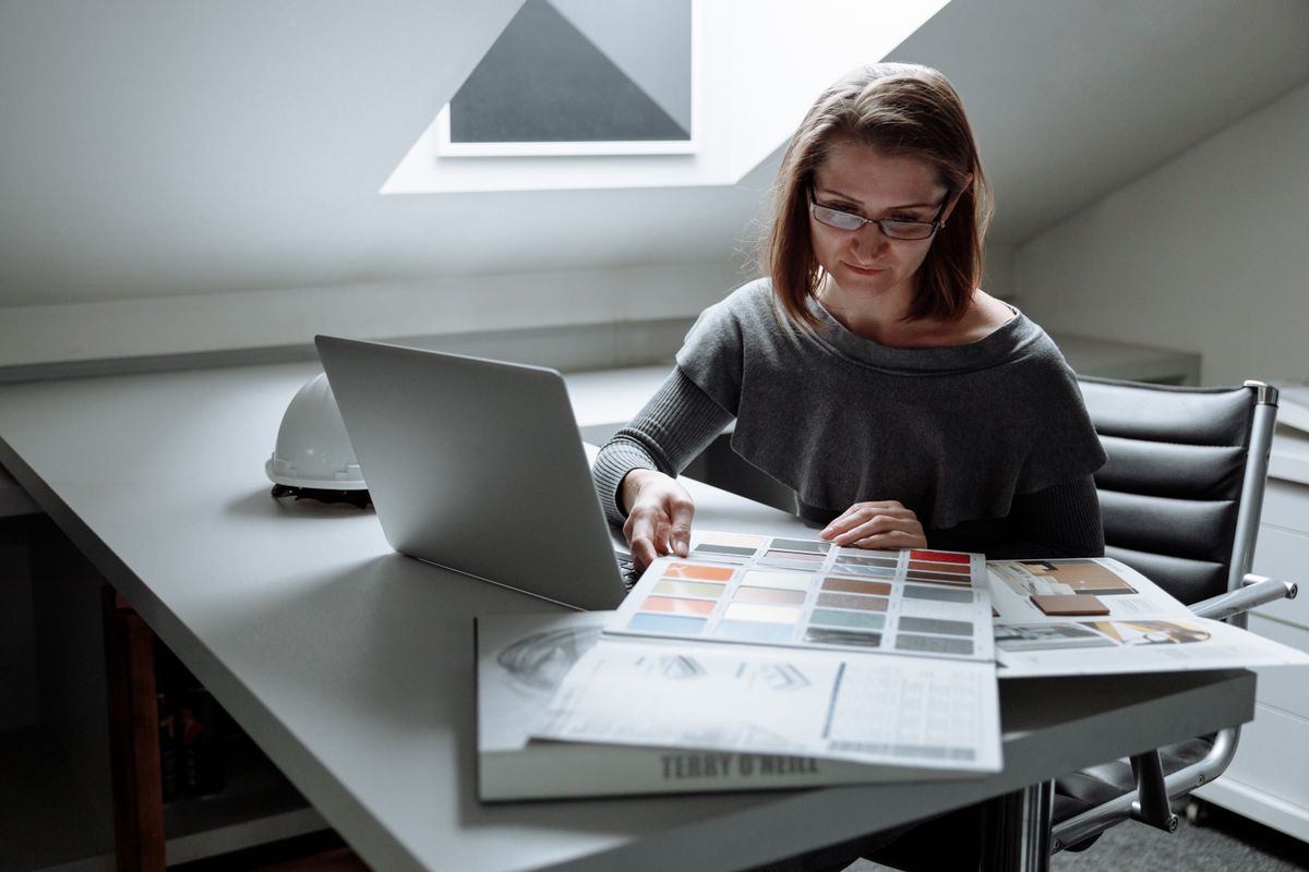 Designer reviewing color palettes at a desk with laptop
