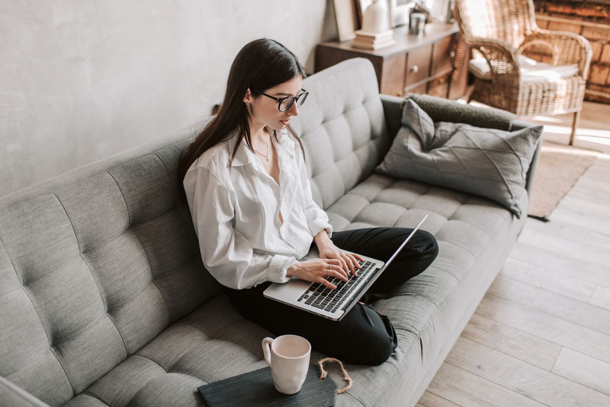Woman working remotely from home with laptop